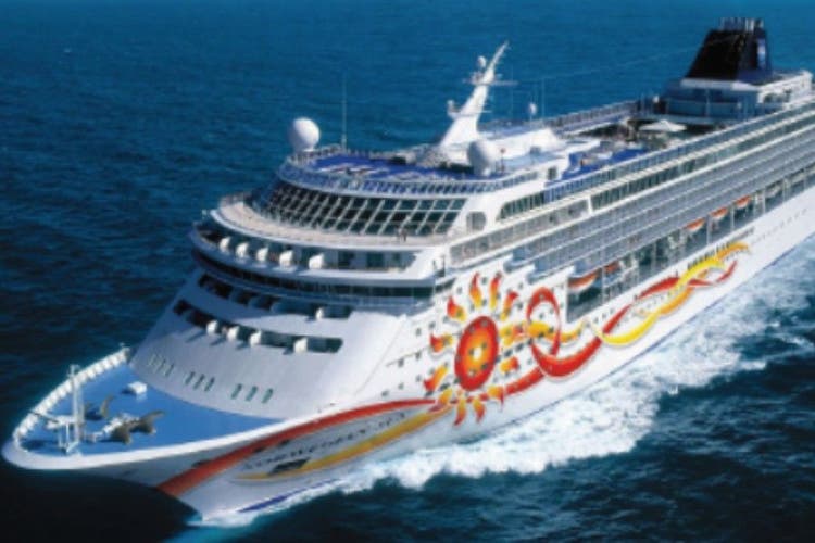 An elevated view of the cruise ship Norwegian Sun cruising through open waters for the Canada to United States section.