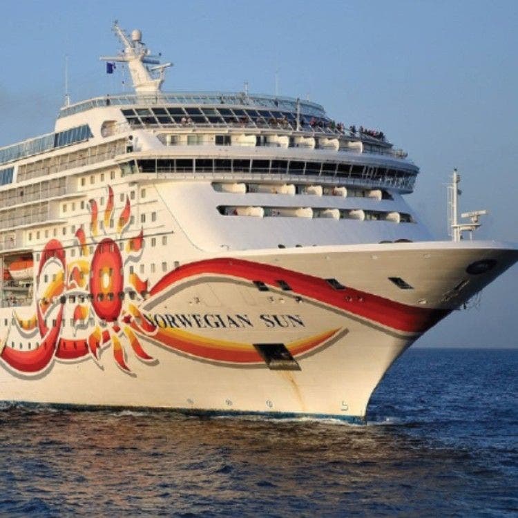 The bow of the Norwegian Sun cruise ship, featuring bright sun artwork, crossing Titanic's channel from Le Havre to Cobh.