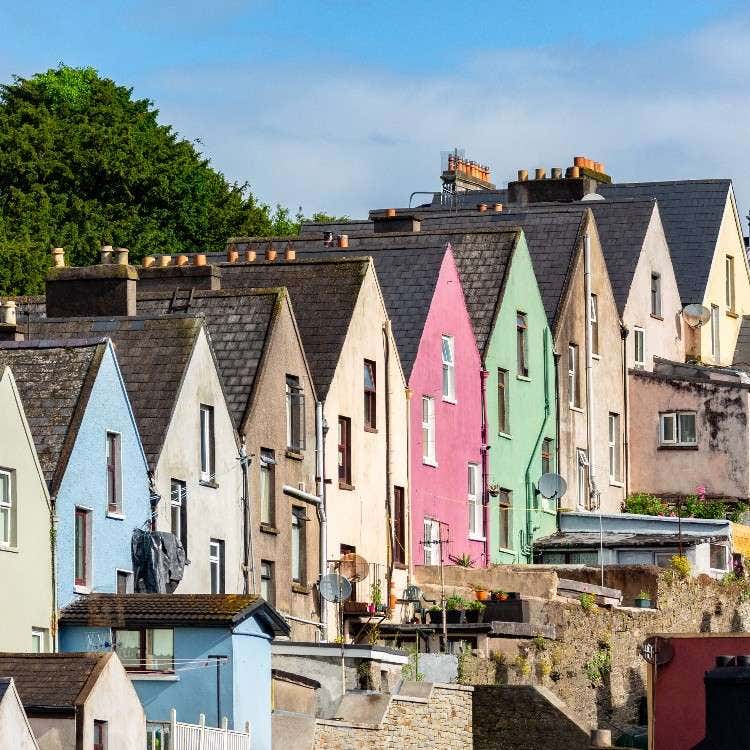 A row of steep, colorful terraced houses known as the Deck of Cards on a hillside in Cobh, Ireland, for the Le Havre to Cobh itinerary section.