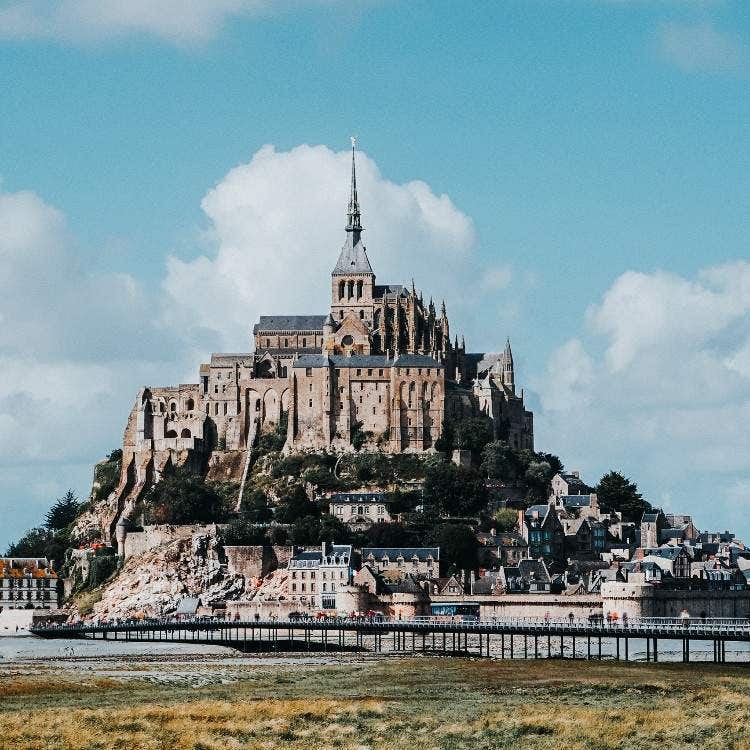 The historic abbey of Mont Saint-Michel standing on its tidal island, a popular excursion destination on a Le Havre to Paris tour.