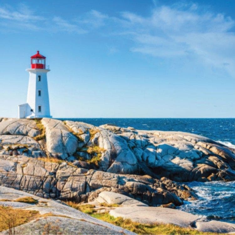 The iconic white and red Peggy's Point Lighthouse standing on weathered granite rocks along the ocean shore in Halifax, Nova Scotia, for the Transatlantic Crossing section.